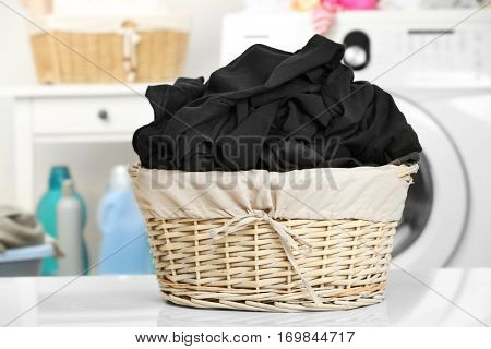 Clothes in wicker basket at laundry