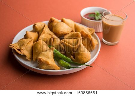 small samosa or mini samosa with sauce and hot tea