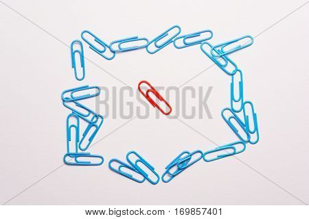 Undaunted red paperclip. Miscellaneous office supplies. Assortment of stationery.