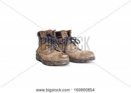 pair of battered old worker boots isolated on white background