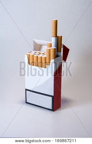 A pack of cigarettes on a white background. Smoking is harmful. Smoking causes death. Nails in the coffin.