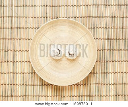 Massage bundles on a plate on bamboo mat. Spa, health, treatment, concept. 