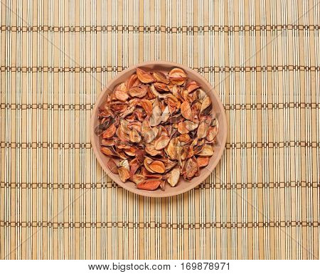 Plate with aroma petals on bamboo mat. Spa, beauty, treatment concept. 