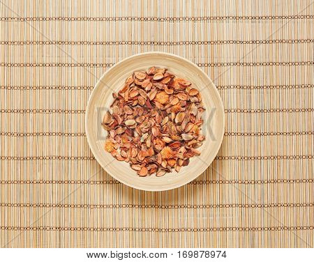 Plate with aroma petals on bamboo mat. Spa, beauty, treatment concept. 