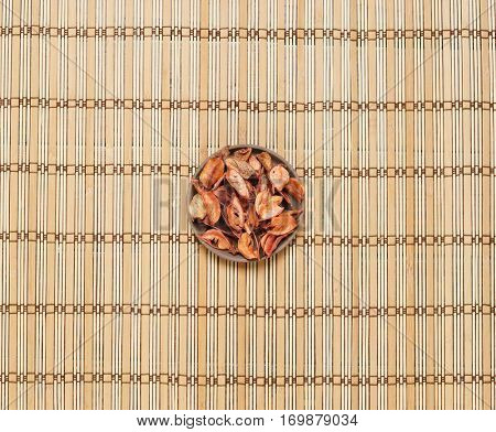 Plate with aroma petals on bamboo mat. Spa, beauty, treatment concept. 