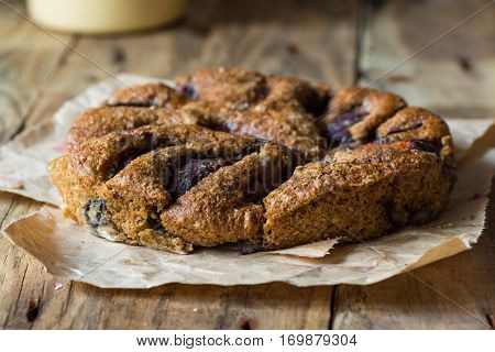 Homemade whole wheat plum cake with coconut milk, eggless, on a rustic wood table