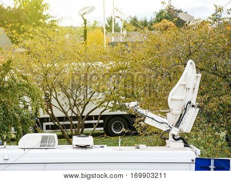 Satellite antenna dish on Tv televison truck live transmission - Tv Televison Truck reporting live the official event