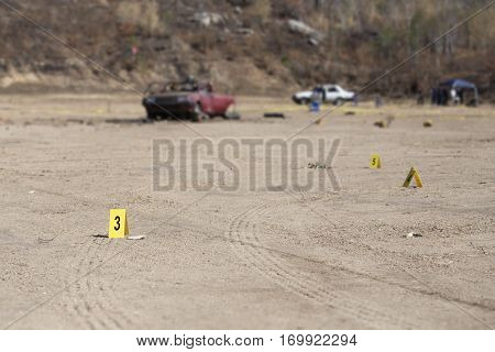 evidence marker and blurred wrecked car with law enforcement background in post blast investigation training with copy space