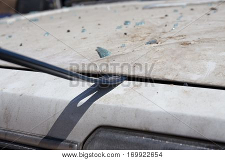 forensic hand in glove lift car bonnet by crowbar to search evidence from car bomb in crime scene investigation training