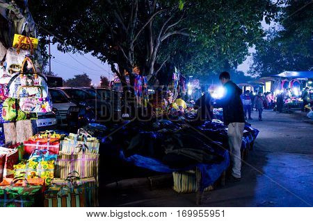 Delhi, India - 28th Jan 2017: Street market in Chandni Chowk near red fort at night. Open shops perfect for low budget items.