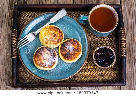 Pancakes with honey on vintage bowl on wooden tray. Studio Photo