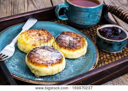 Pancakes with honey on vintage bowl on wooden tray. Studio Photo