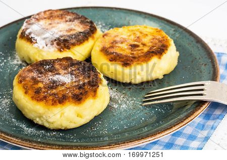 Curd cheese pancakes on the plate on white background. Studio Photo
