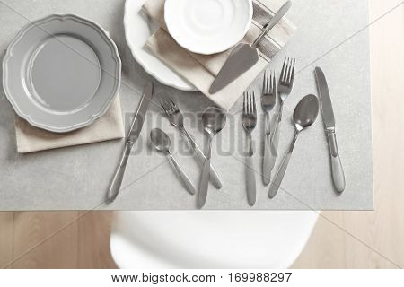 Cutlery set with plates on gray table,top view