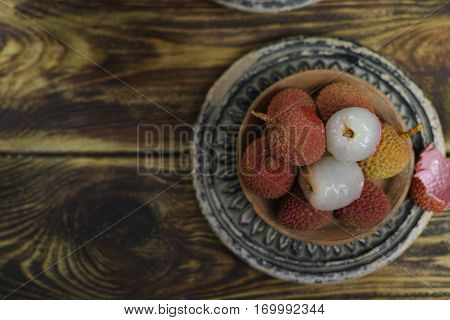 Tropical fruit - Lychees on wooden background