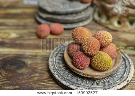 Tropical fruit - Lychees on wooden background