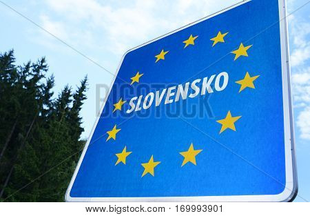 Staged photo with Slovak border sign on the road.