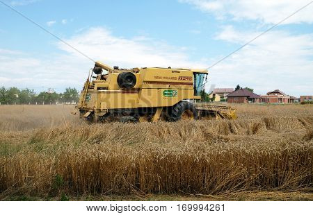 TRNOVEC, CROATIA - JULY 09, 2016: Combine harvester harvest ripe wheat on a farm in Trnovec, Croatia on July 09, 2016