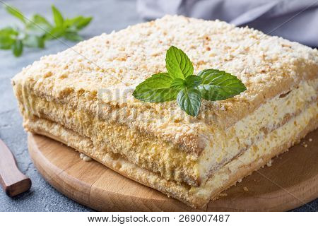 Layered Cake With Cream Napoleon Millefeuille Vanilla Slice With Mint On Dark Background.