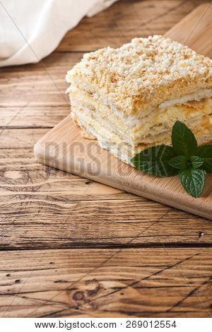 Layered Cake With Cream Napoleon Millefeuille Vanilla Slice With Mint On Wooden Background.