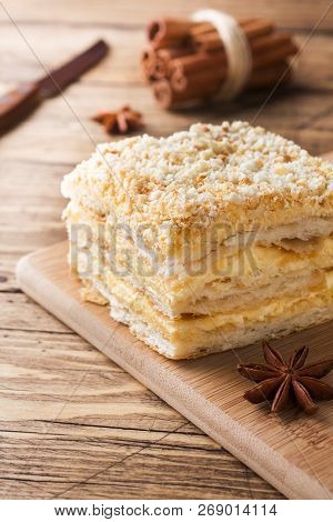 Layered Cake With Cream Napoleon Millefeuille Vanilla Slice With Cinnamon And Anise On Wooden Backgr