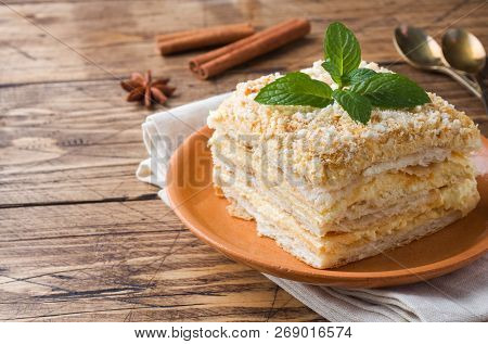 Layered Cake With Cream Napoleon Millefeuille Vanilla Slice With Mint On Wooden Background.