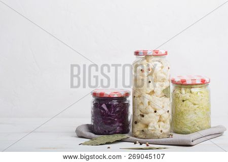 Sauerkraut In Jars On A Wooden Table