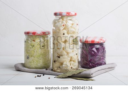 Sauerkraut In Jars On A Wooden Table