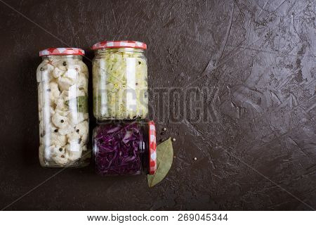Sauerkraut In A Blue Bowl On A Wooden Table. Top View