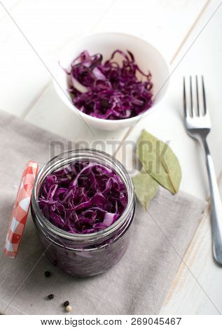 Purple Sauerkraut In Jars On A Wooden Table