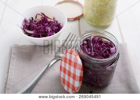 Homemade Fermented Cabbage In Jars On A Wooden Table