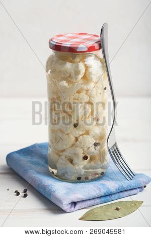 Fermented Cauliflower In A Jar On A Wooden Table