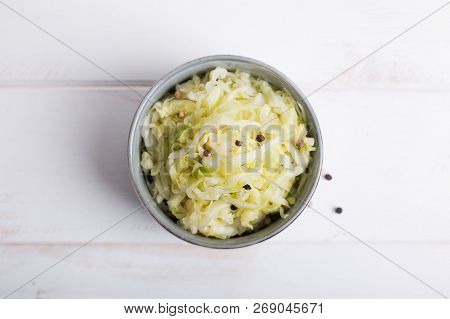 Sauerkraut In A Blue Bowl On A Wooden Table
