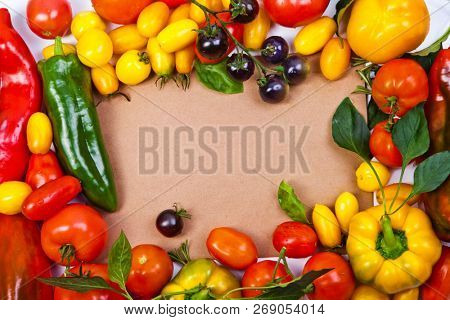 Assorted tomatoes and vegetables isolated on white background. Photo for your design