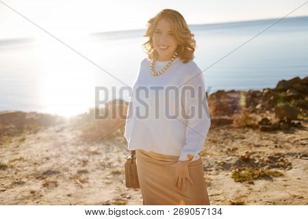Pregnant Young Woman Walking Near The River