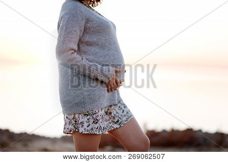 Pregnant Woman Wearing Sweater While Walking Outdoor