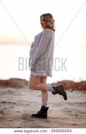 Pregnant Woman Wearing Sweater While Walking In The Evening