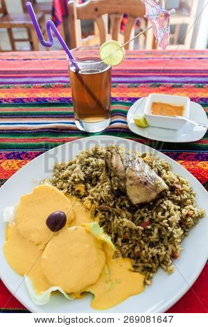Meal In Peruvian Restaurant. Rice With A Chicken. Potatoes With A Sauce. Aji De Gallina.