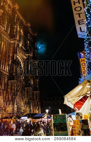 Strasbourg, France - Nov 29, 2017: Vmajestic Notre-dame Cathedral And Maison Kammerzell Decorated Wi