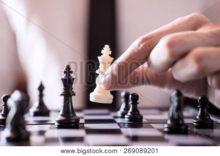 Hand Of Confident Businessman Use King Chess Piece White Playing Chess Game To Development Analysis 