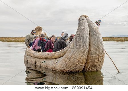 Titicaca, Peru - May 15, 2015: Visitors On A Reed Boat Near Uros Floating Islands, Titicaca Lake, Pe