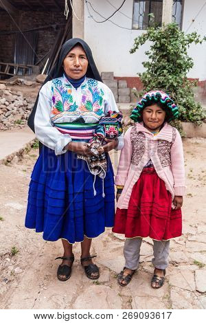 Amantani, Peru - May 15, 2015: Members Of A Native Family Living On Amantani Island In Titicaca Lake