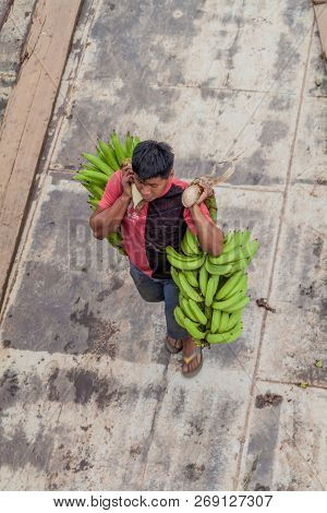 Napo, Peru - July 14, 2015: Cargo Boat Crew Transports Bunches Of Plantains To The Boat Deck. Cargo 