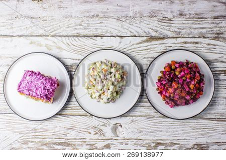 Assortment Salad Of Russian Cuisine - Olivier Salad, Vinaigrette - Beet Salad, Herring Salad.