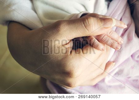 Baby Holding Mother`s Hand. The Concept Of Care, And Tenderness Of Motherhood. Stock Image.