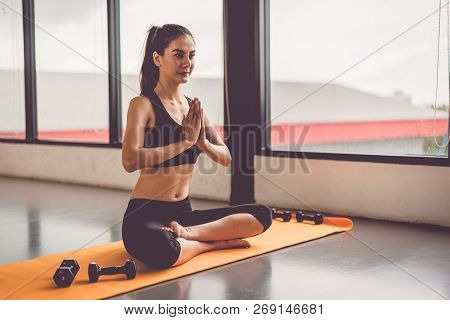 Beauty Woman Doing Yoga And Raise Hand Or Pay Obeisance In Fitness Workouts Training Gym Center.  Li