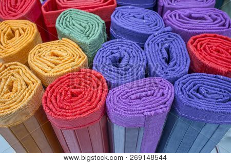 Loads Of Many Rolled Colorful Light Ratan Carpets. Closeup