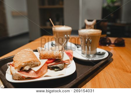 Breakfest Snack - Coffee Latte And Bocadillo Sandwich On Table In One Cafe