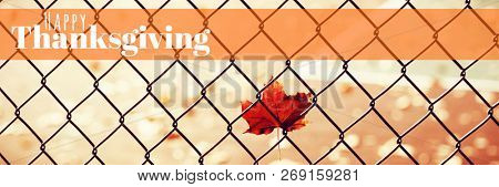 Digitally generated image of happy thanksgiving text against maple leaf in front of a tennis court