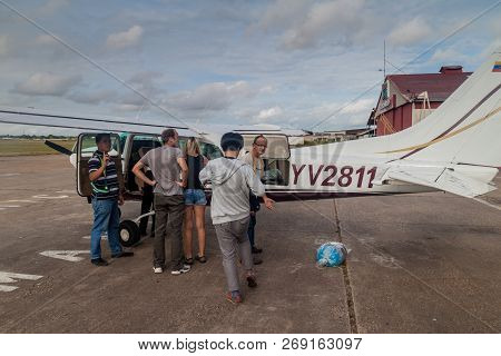 Ciudad Bolivar, Venezuela - August 16, 2015: Passengers Enter Small Cessna 210 Centurion Airplane At